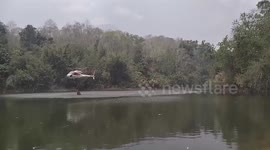 Helicopters dump water on wildfire in smoke-ridden northern Thailand