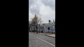 People pay homage to the fallen heroes, walking along the wall of the Mykhailivsky Cathedral complex in Kyiv, Ukraine, where thousands of portraits are displayed
