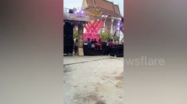 Locals take part in bottle sucking game in Cambodia