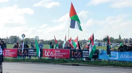 Palestine protestors at the start of the London Marathon attempt to raise awareness as the elite Wheelchair race starts