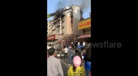 Crane delivers rescuer to save boy trapped in blazing apartment in China