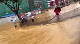 Residents use giant net to snag fish on flooded streets in southern China