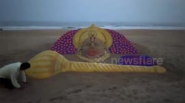Sand Artist creates a beautiful sand sculpture of Lord Hanuman at Puri beach on Hanuman Jayanti on Northern India