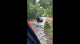 Men Push Car Through Flooded Street