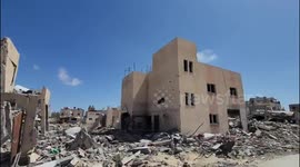 Palestinians inspect residential buildings that were destroyed during Israeli raids amid the ongoing conflict between Israel and Hamas, in Khan Yunis, southern Gaza Strip