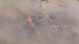 Bird's eye view shows agricultural fire razing field in northern Thailand