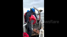 USA: Members of the U.S. Coast Guard deploy buoys