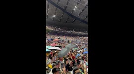 Thousands of concert-goers wave umbrellas in rain-soaked Manila