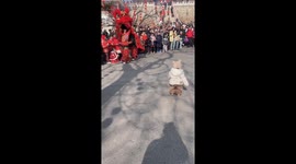 Playful encounter: child and lion dance surprise