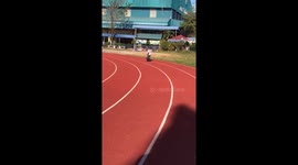 Determined boy keeps falling over because of backpack