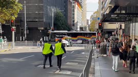 NSW police block off road during ANZAC Day Parade with LGBT bus on