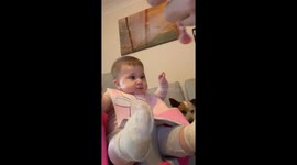 Giggles erupt as a little foodie conquers the creamy banana frontier