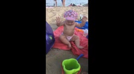 Unfamiliar shores: Little girl's first encounter with sand ends in tears