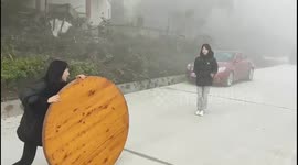 China: Women's attempt to navigate a tabletop failes in Chongqing