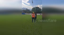 Disaster response teams fill helicopter buckets with water to aid firefighting efforts in Guatemala