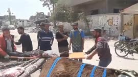Gaza: Palestinian medics transport individuals after Israeli strike