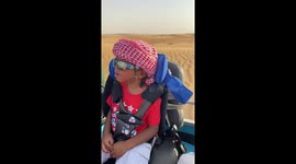 Cool kid enjoying a desert safari jeep ride during Dubai trip