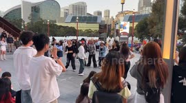 Asian youngsters practice dance moves in Darling Harbour, Sydney, Australia