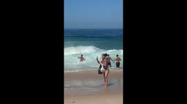 Lifeguards brave rough waves to rescue drowning swimmer at Copacabana Beach