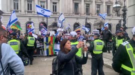 Pro-Palestine protesters taunt pro-Israel counter protestors in London by holding a giant key aloft as symbol of return to homes lost during the Nakba