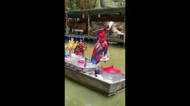 Spider-Man sells food on canal boat in Thailand