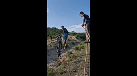 Banna tribe members walking on stilts in Ethiopia