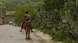 To school on the back of a donkey.
