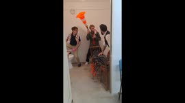 A band performs an impromptu instrumental performance in the bathroom.