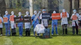 Disabled campaigners dressed in medical uniforms rally against assisted dying under backdrop of Parliament