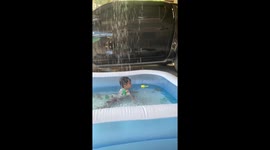 Baby cools off in paddling pool during Philippines heat wave