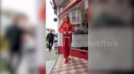 Woman obsessed with orange - wears shades of it every day, has orange hair and flat