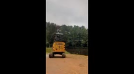A mini excavator crashes into the ground