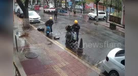 Two delivery riders almost crushed underneath massive falling tree
