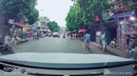 Motorcyclist's head is almost run over in nail-biting close call captured in Vietnam