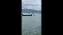 Huge waterspout tornado weaves between boats on Thai island