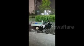 Driverless tricycle navigates college amid hailstorm in northern China