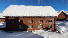Is there a more satisfying sight? Thick snow cascades off house roof in China