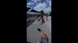 Bike mishap: fakie trick gone wrong at skate park