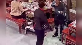 Choking man saved by doctor sitting on next table using the Heimlich manoeuvre