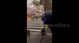 China: Powerful winds knock down pedestrians