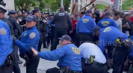 USA: NYPD police lead two protesters away in handcuffs