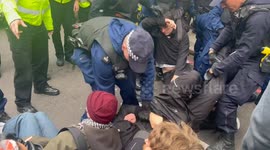 Police drag protests out of road after coach set to transport asylum seeker was blocked in London