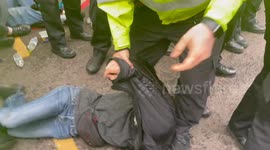 Tensions flare as protestors confront police in London refugee protest