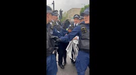 A Woman is detained on Peckham road during anti immigration protests