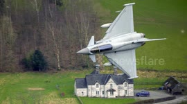 RAF Typhoon (Eurofighter) pair flying in close formation, low level in the Mach Loop (LFA7) on 21/03/24