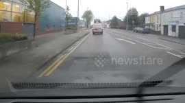 Driver crashes into the back end of a yellow bus at. Bus stop