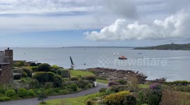 Sailing boat hits rocks in St Mawes Cornwall and sailors being rescued by RNLI