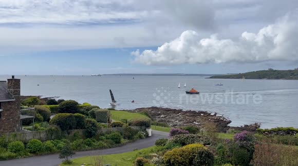 Sailing boat hits rocks in St Mawes Cornwall and sailors being rescued by RNLI