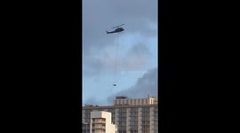 Military helicopter in Waikiki Hawaii delivers new AC for Twin Fin Hotel | How giant AC Units are delivered to Hotels in Waikiki, via Helicopter