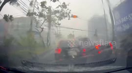 Power lines explode above cars during storm in Thailand